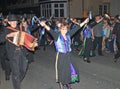 SIDMOUTH, DEVON, ENGLAND - AUGUST 10TH 2012: A group of musicians and clog dancers dressed in mauve and green and holding their