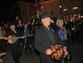 SIDMOUTH, DEVON, ENGLAND - AUGUST 10TH 2012: A group of musicians and clog dancers dressed in mauve and green take part in the