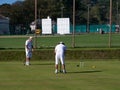 SIDMOUTH, DEVON, ENGLAND - SEPTEMBER 20,2019: Two elderly gentlemen enjoying a game of croquet in the late summer sun.