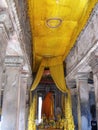 Altar with Buddhas decorated with fabrics inside the Angkor Wat temple in the Khmer temple complex of Angkor Royalty Free Stock Photo