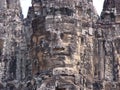 Face sculpted in stone in the Khmer temple complex of Angkor