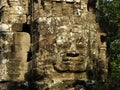 Face sculpted in stone in the Khmer temple complex of Angkor