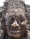 Face of smiling woman carved in stone at Bayon Temple in Angkor Khmer temple complex