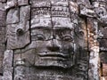 Female face sculpted in stone in the Khmer temple complex of Angkor