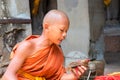 Siem Reap, Cambodia - April, 13,2018: Young monk reads mantras. Praying buddhist monk.