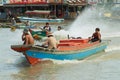 People ride motor boat at the floating market at the Tonle Sap lake in Siem Reap, Cambodia. Royalty Free Stock Photo
