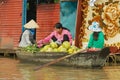 Women buy and sell food from the boat at the floating market at Tonle Sap lake in Siem Reap, Cambodia. Royalty Free Stock Photo