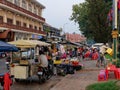 A colorful street market in Cambodia, vendors near shopping carts