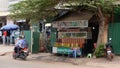 An image capturing a small roadside kiosk displaying an array of vegetables, fruits, spices