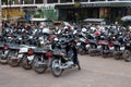 Large number of mopeds in the parking lot. Parking lot on the street of an Asian city.