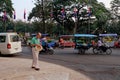 A lone elderly respectable white-skinned man walking down a street in a Cambodian city