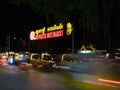 Night market, traffic on the road, motion blur