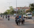 People on mopeds ride on a city street. Typical traffic in an Asian city. City life