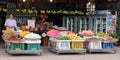 Photograph capturing an Asian male seller stationed near a counter displaying an array of