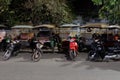 Rickshaws parked on a city street, Asian taxi