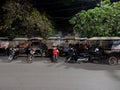 Rickshaws parked on a city street, Asian taxi