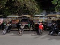 Rickshaws parked on a city street, Asian taxi