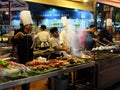 Street kitchen restaurant, cooks prepare food outside