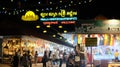 Tourists stroll through the night market, street trading