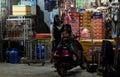 Two small Cambodian girls near a motor scooter. Little street shop. Happy smiling children