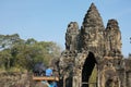 Tourists pass the south gate of Angkor Thom on an elephant