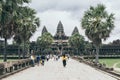 Siem Reap, Cambodia - June 2019: tourists walking towards main temple of Angkor Wat