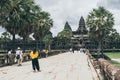 Siem Reap, Cambodia - June 2019: tourists walking towards main temple of Angkor Wat