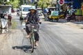 Siem Reap, Cambodia, March 19, 2016: A woman riding a bicycle on