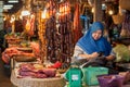 Marketplace with choice of sausages and meat vendor waiting for customers