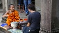 Siem Reap, Cambodia Nov 16, 2017 - Buddhist monk blessing tourists in Angkor Wat temple