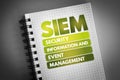 SIEM - Security Information and Event Management acronym on notepad, business concept background