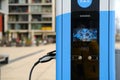 Siemens eMobility charging, street, charging with electricity through cable, electric vehicle in European city, energy