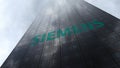Siemens logo on a skyscraper facade reflecting clouds. Editorial 3D rendering