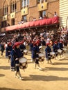 Tourists watching the colorful and fancy traditional costume parades at the horse race, Palio di Siena, held in medieval square