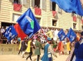 Tourists watching the colorful and fancy traditional costume parades at the horse race, Palio di Siena, held in medieval square Royalty Free Stock Photo