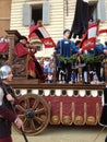 Tourists watching the colorful and fancy traditional costume parades at the horse race, Palio di Siena, held in medieval square Royalty Free Stock Photo