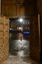 Siena by night. View of the Piazza del Campo with a frame of a studded door. Royalty Free Stock Photo
