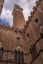 Siena Tower - Looking up towards Torre del Mangia Mangia tower from inside of Palazzo Publico inner courtyard in Siena, Tuscany Royalty Free Stock Photo