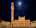 Siena, Tuscany, Italy: night view of the ancient town hall Palazzo Pubblico and the tower Torre del Mangia Royalty Free Stock Photo