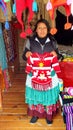 A Native Mexican Woman displays a knitted sweater at the main entrance to the Sierra Chincua Monarch Butterfly Sanctuary