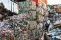 Cubes of crushed and stacked cans and other waste in a junkyard