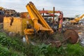 Pieces of abandoned industrial machinery in a scrap yard