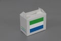 Sierra leonean flag on white box with barcode and the color of nation flag on grey background. The concept of export trading from