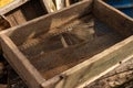 Sieve for sifting sand from stones during construction. An old village sieve for building bulk materials lies in a Royalty Free Stock Photo