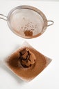 Sieving coco powder onto Chocolate muffin Royalty Free Stock Photo