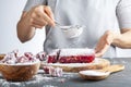 Sifting confectioners sugar on top of a dessert