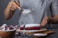 sifting confectioners sugar on top of a dessert