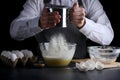 Sifting flour on dark background. recipe of pie or cake making concept Royalty Free Stock Photo