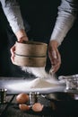 Sifting flour by female hands