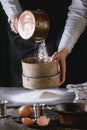 Sifting flour by female hands Royalty Free Stock Photo